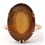 A 9ct stamped citrine dress ring, oval shaped (20 x 14mm), faceted design, claw set and raised in