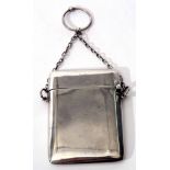 George V card case of plain polished rectangular form with hinged cover and chain suspension with