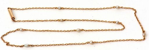 A 15ct stamped chain interspersed with 9 small seed pearls, gross weight 2.6gms