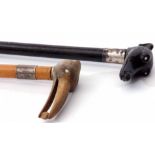 Mixed Lot: comprising two various walking canes, the first with ebonised shaft to a white metal