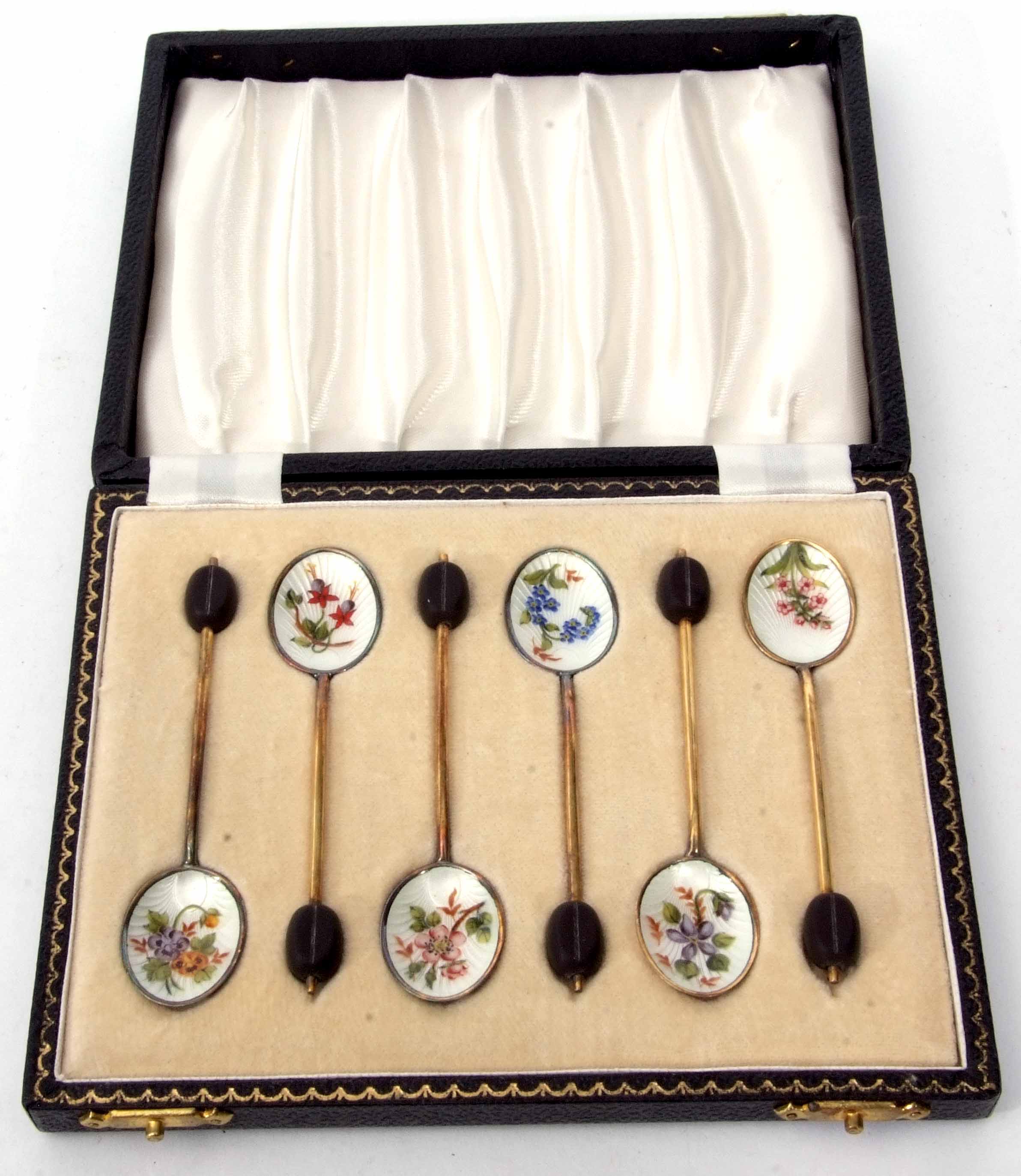 Cased set of six Elizabeth II silver gilt and enamelled coffee spoons, each with coffee bean finials