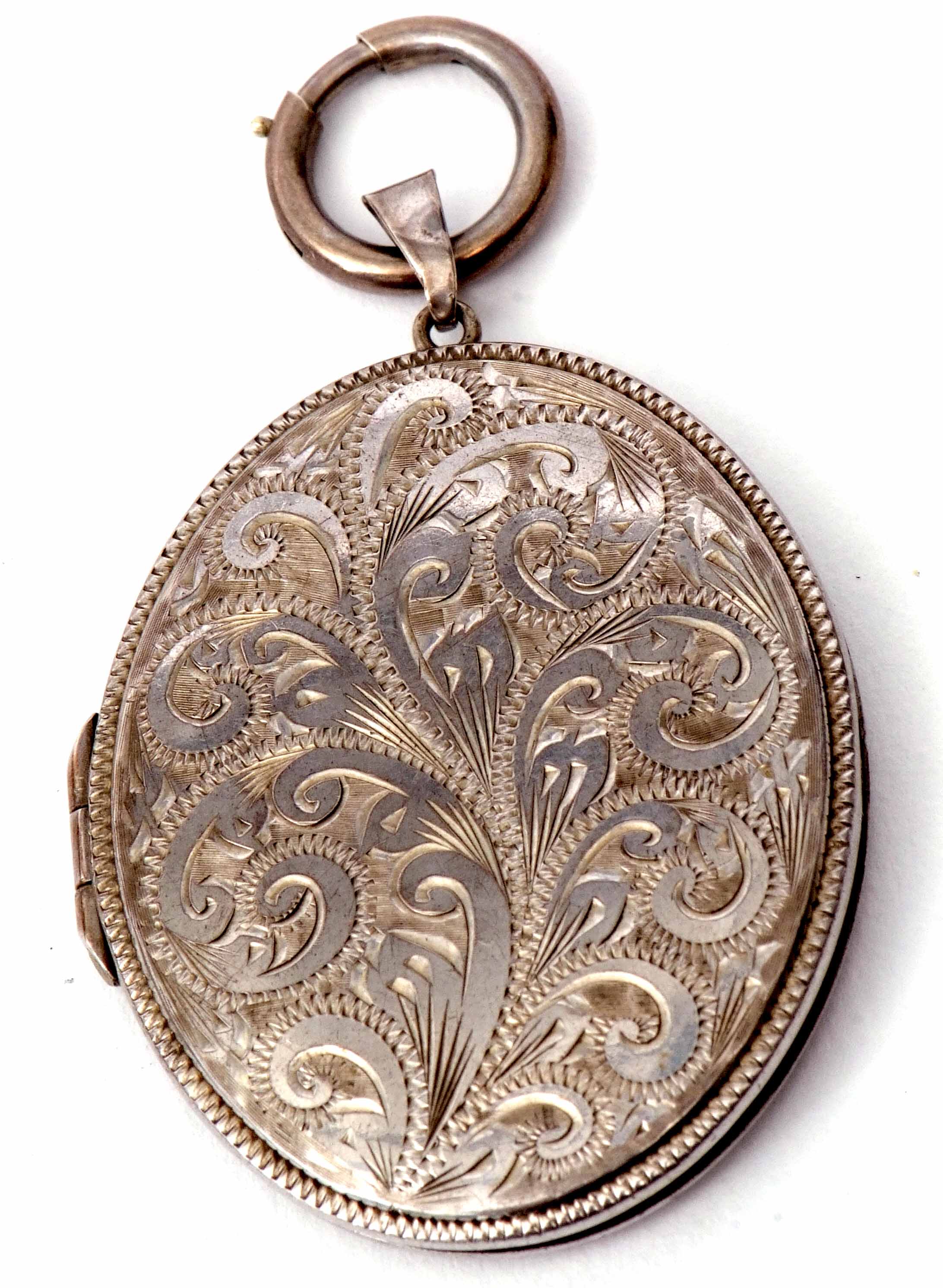 Hallmarked silver large oval locket chased and engraved with a foliate design, verso plain polished,