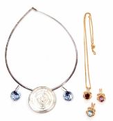 Mixed Lot: three modern pendants, a garnet, amethyst and blue topaz example, each highlighted with a