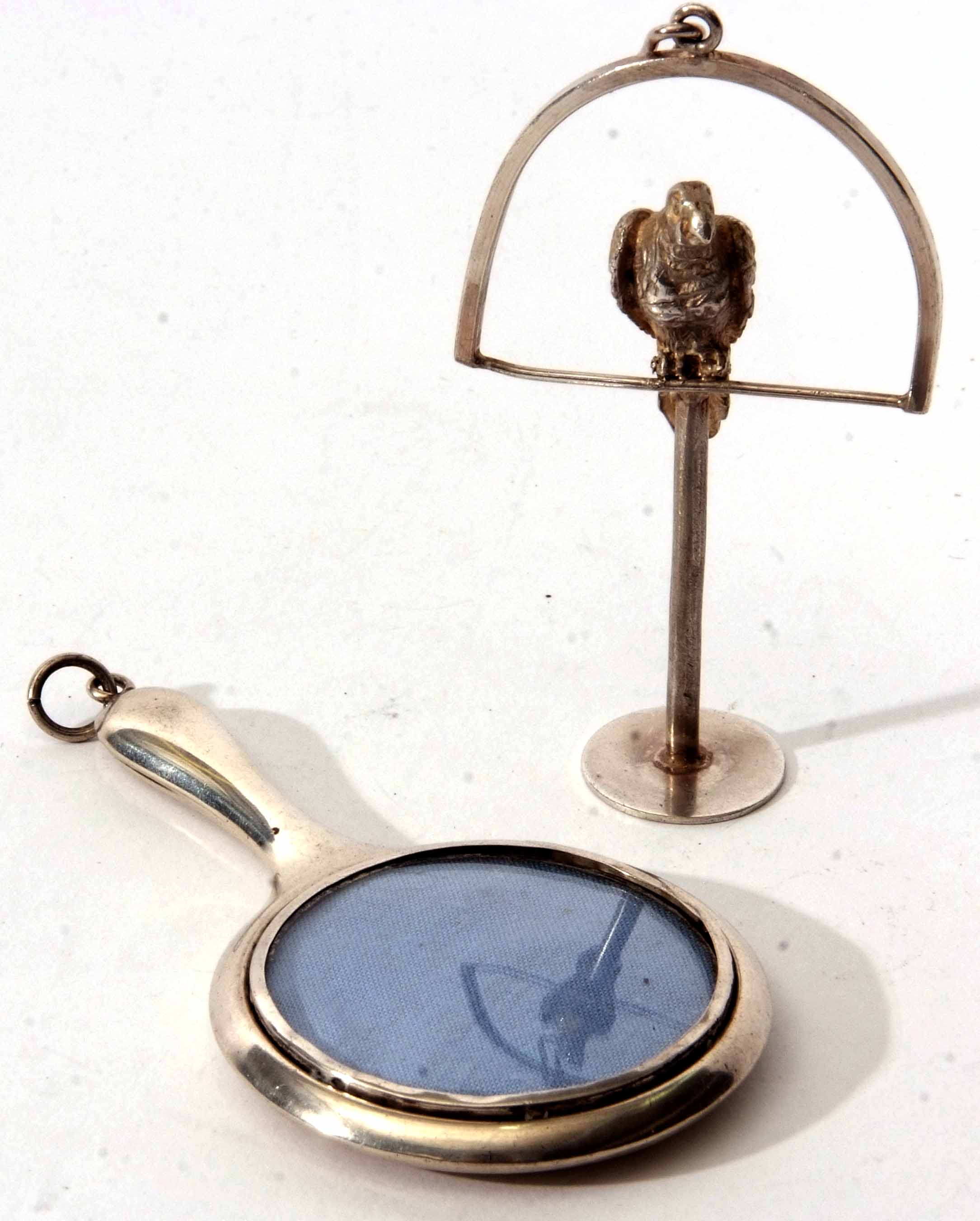 Mixed Lot: comprising a polished novelty hand mirror (lacking glass) with ring suspension together