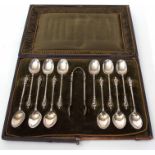 Cased set of 12 late Victorian figural tea spoons and matching sugar tongs combined weight approx