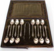Cased set of 12 late Victorian figural tea spoons and matching sugar tongs combined weight approx