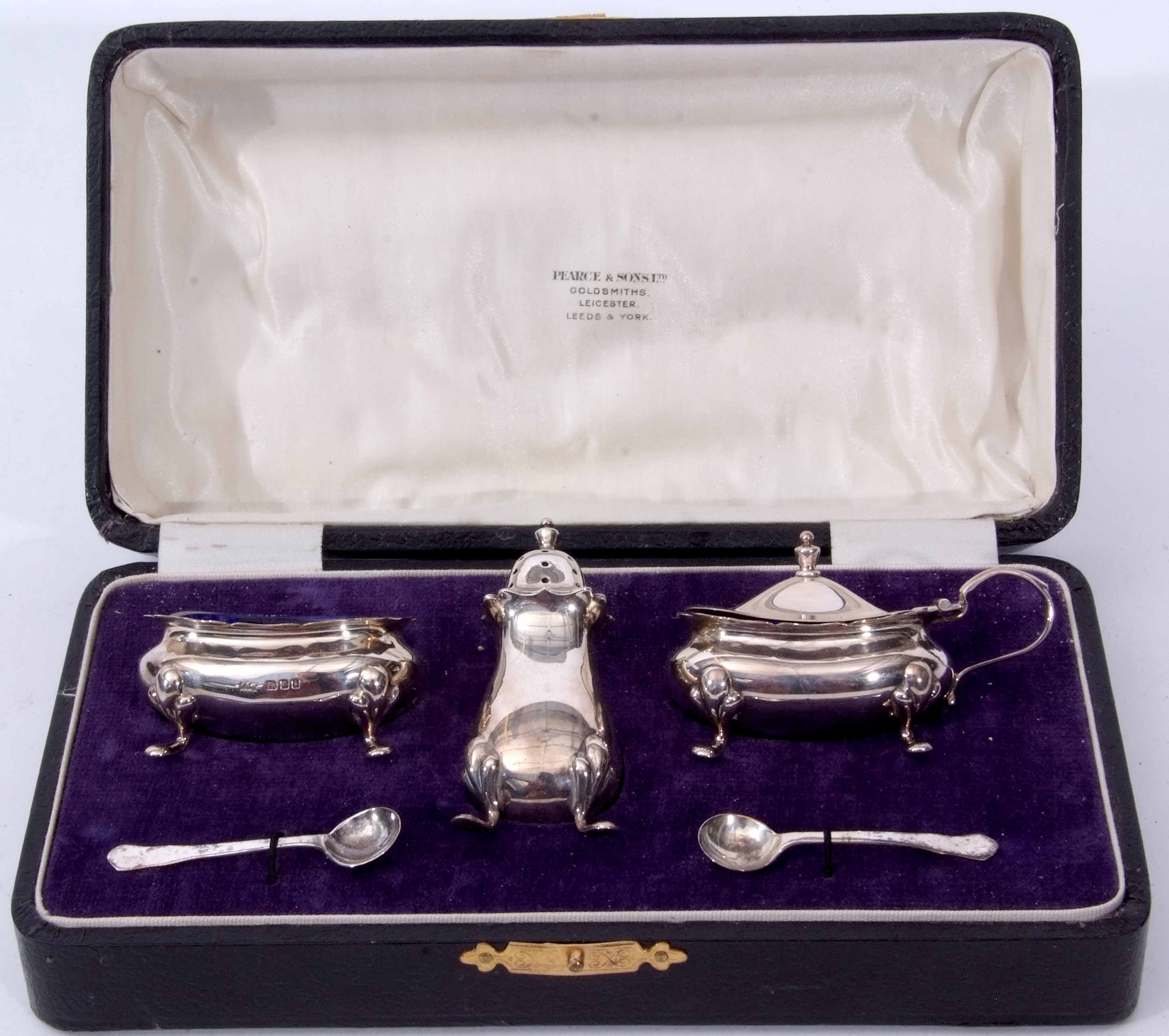 George V cased three piece cruet set comprising pepper caster, open salt and lidded mustard, each of