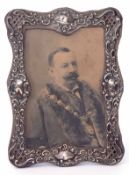 Edward VII silver mounted easel backed photograph frame, the shaped rectangular mount of lattice,