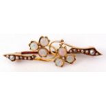 Opal and seed pearl brooch, a design of two flowerheads, each with three circular cut opals,