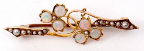 Opal and seed pearl brooch, a design of two flowerheads, each with three circular cut opals,