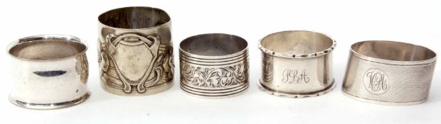 Mixed Lot: comprising three various silver napkin rings including cylindrical and oval forms,