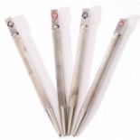 Cased set of four white metal Bridge pencils, each of engine turned cylindrical form and each