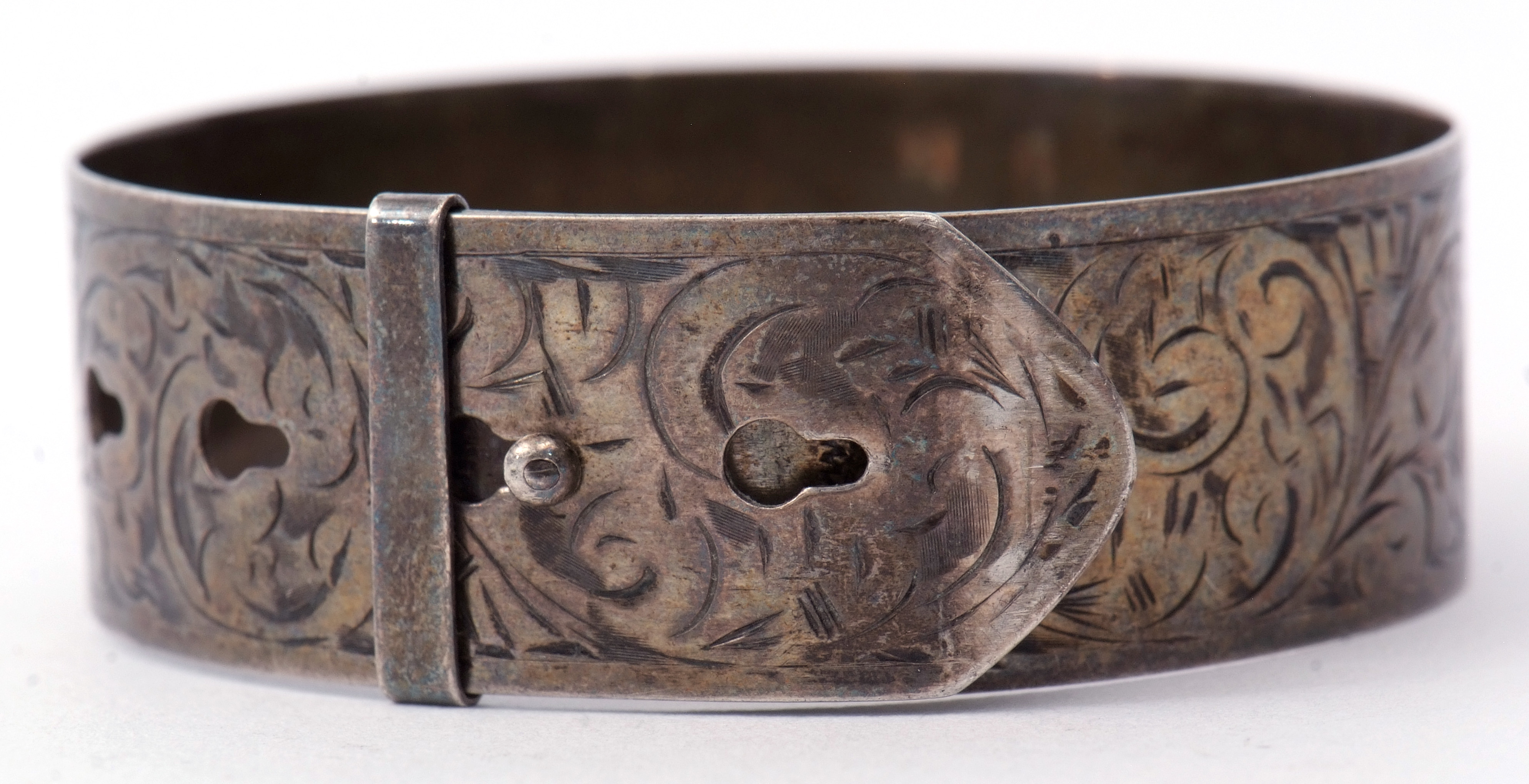 Hallmarked silver belt design bangle, chased and engraved with a foliate design, hallmarked Chester,
