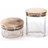 Two George VI silver lidded and clear cut glass toiletry bottles, each with plain polished pull