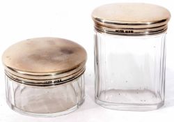 Two George VI silver lidded and clear cut glass toiletry bottles, each with plain polished pull