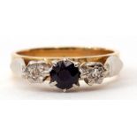 An 18ct gold sapphire and diamond ring, the circular cut faceted sapphire flanked by two small