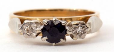 An 18ct gold sapphire and diamond ring, the circular cut faceted sapphire flanked by two small