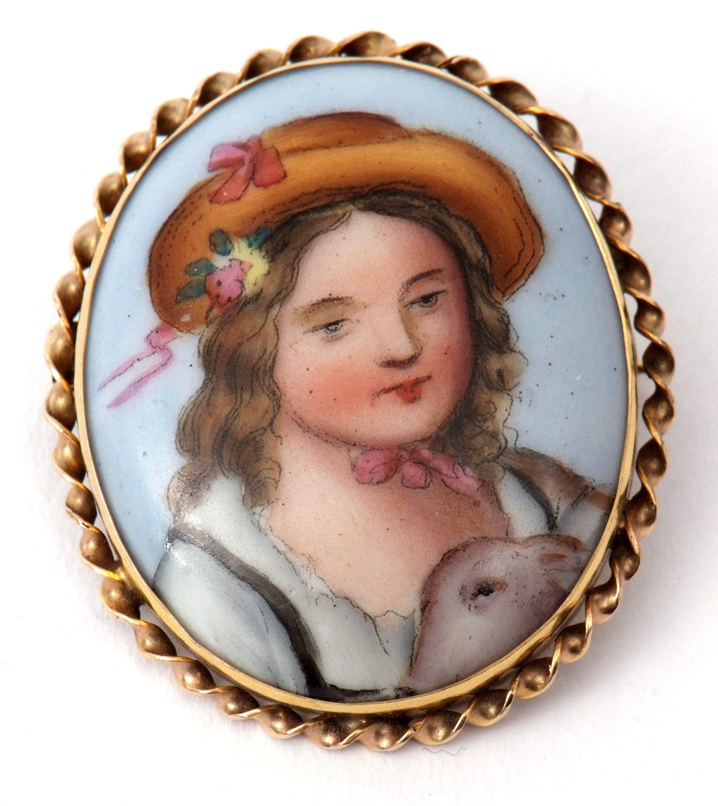 Hand painted porcelain brooch, a portrait of a young lady wearing a bonnet, 3.5 x 2.5cm, framed in a