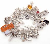 White curb link bracelet suspending various charms, mainly cats, 132gms gross weight