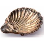 Edward VII shell butter dish of typical scalloped form with polished thumb piece and raised on three