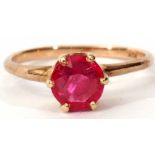 Modern ruby ring of circular faceted design, claw and coronet set in a plain 10K stamped mount, size