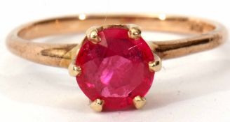 Modern ruby ring of circular faceted design, claw and coronet set in a plain 10K stamped mount, size