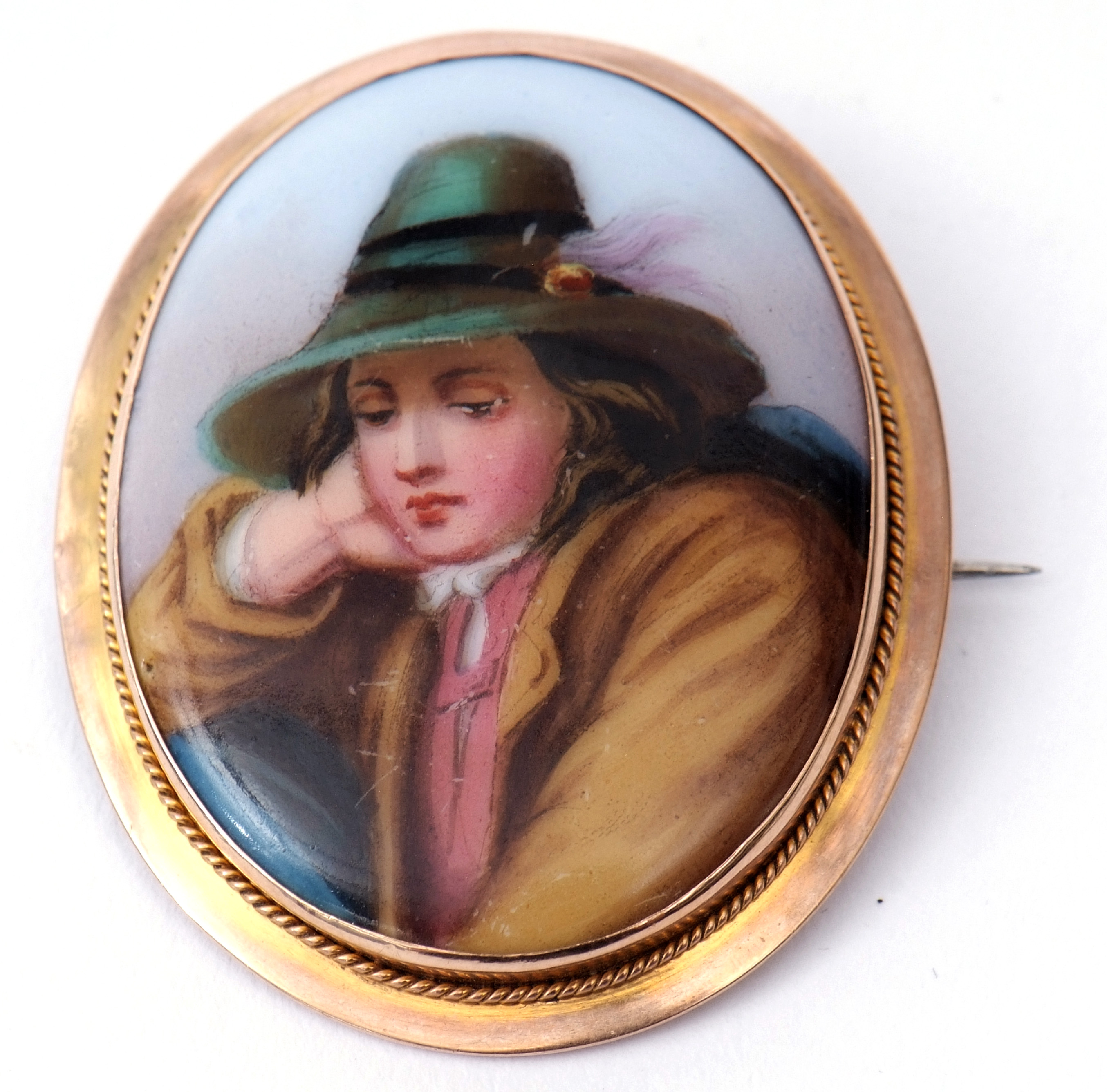 Antique hand painted porcelain brooch of oval shape, a three quarter length pose of a young lady