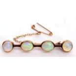 Opal bar brooch featuring two oval and two circular shaped cabochon opals, each collet set, 4.5cm