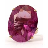 Large oval shaped amethyst dress ring, faceted cut and raised in a four claw basket mount, stamped