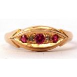An 18ct gold ruby and diamond ring, boat shaped featuring three graduated rubies interspersed with