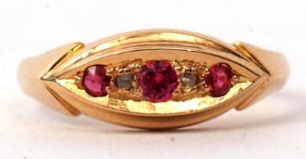 An 18ct gold ruby and diamond ring, boat shaped featuring three graduated rubies interspersed with