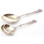 Edward VII cast serving spoon with figural handle and polished bowl with gilt lining together with a