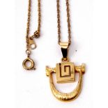 Stylised modern pendant, stamped 585, 3.6gms, on a gilt metal chain