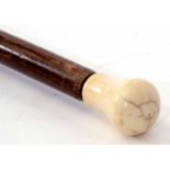 A 19th century ivory mounted rosewood walking stick, the ogee carved and polished handle to a