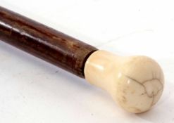 A 19th century ivory mounted rosewood walking stick, the ogee carved and polished handle to a