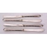Four George V dessert knives with plain polished blades and hard soldered cast and applied