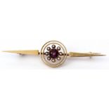 A 15ct amethyst and seed pearl bar brooch, a plain polished open work design with a central bezel