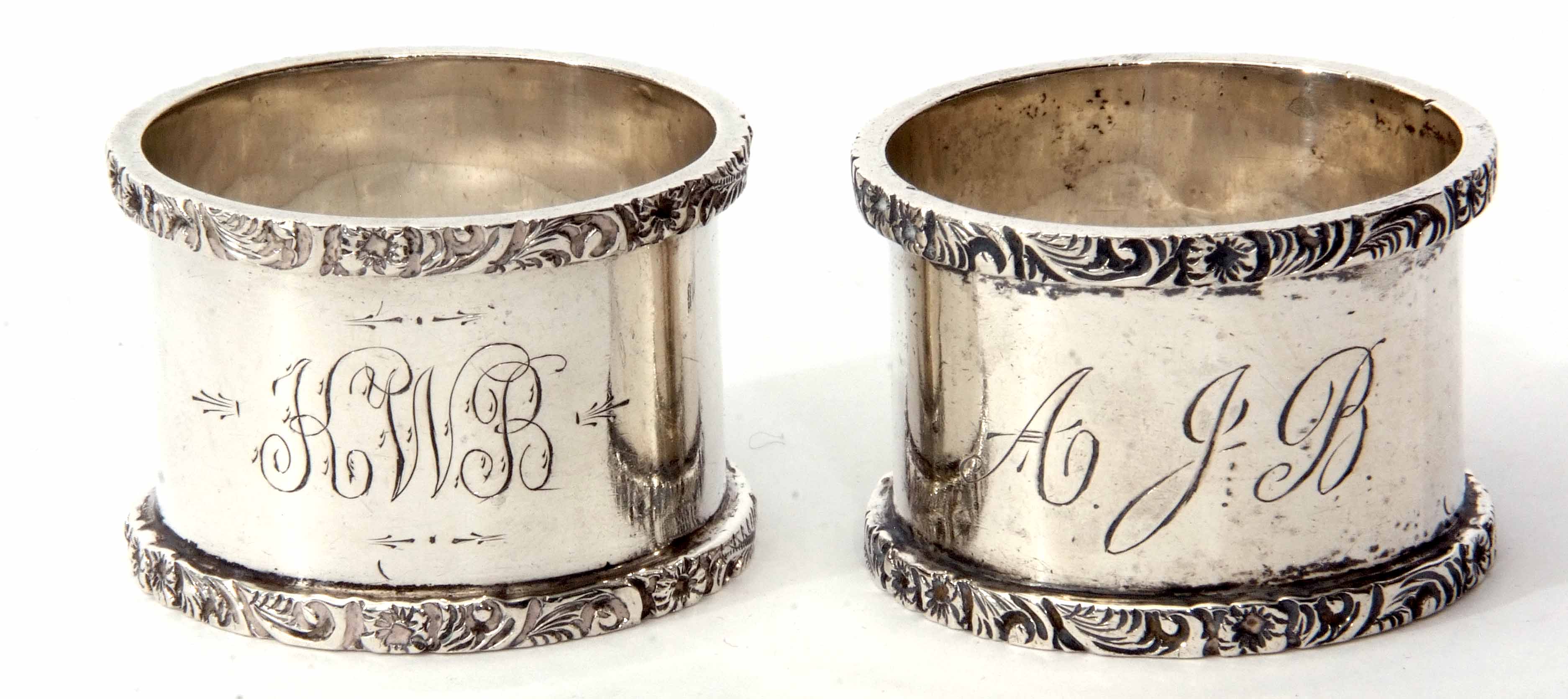 Two Edward VII cylindrical napkin rings, each of polished form with cast and applied rims and