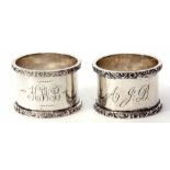Two Edward VII cylindrical napkin rings, each of polished form with cast and applied rims and