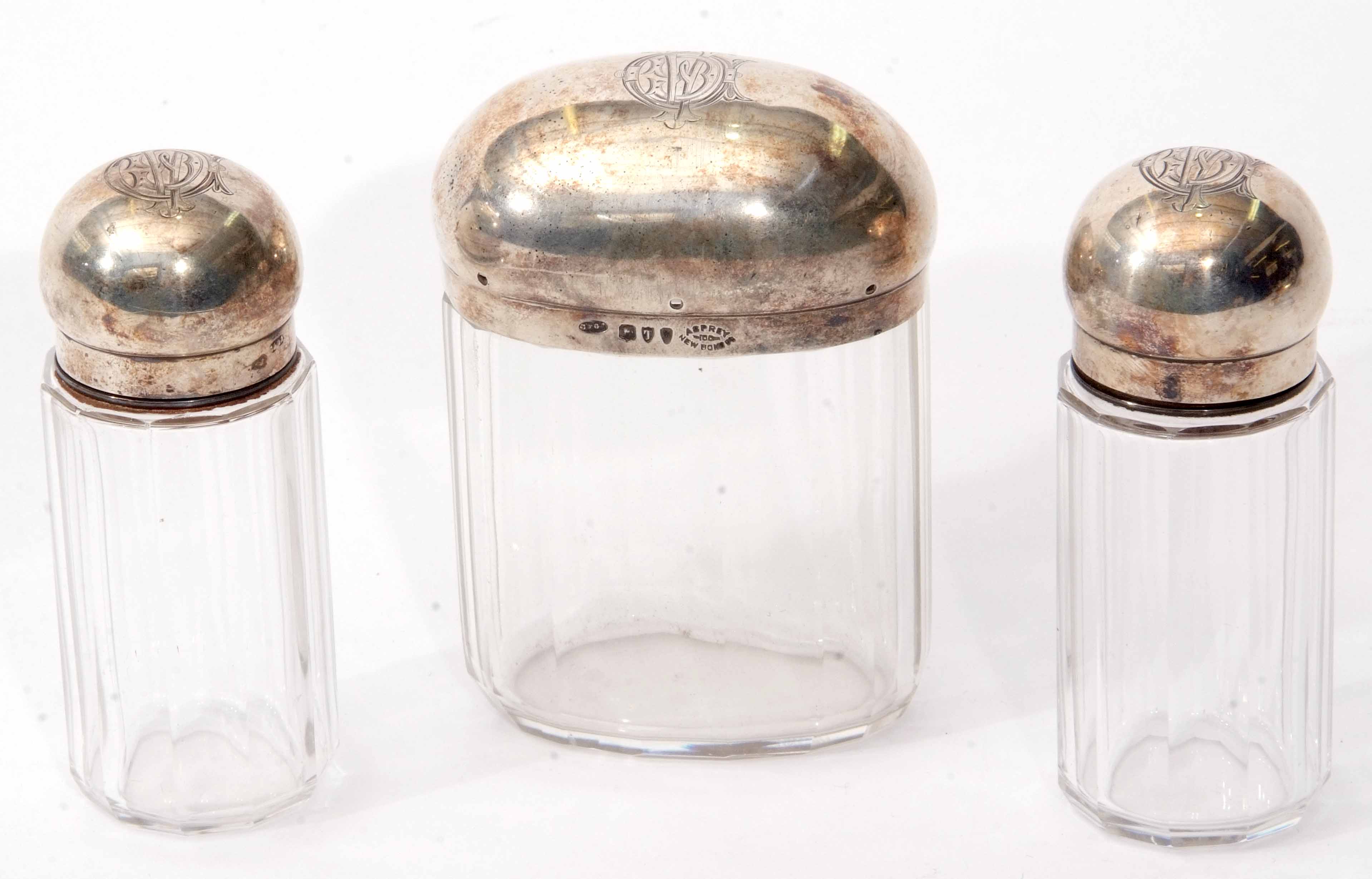 Three various Victorian toiletry bottles, two of cylindrical form with screw down covers, the