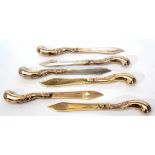 Six German silver gilt dessert knvies each with stylised foliate pistol grip handles and engraved