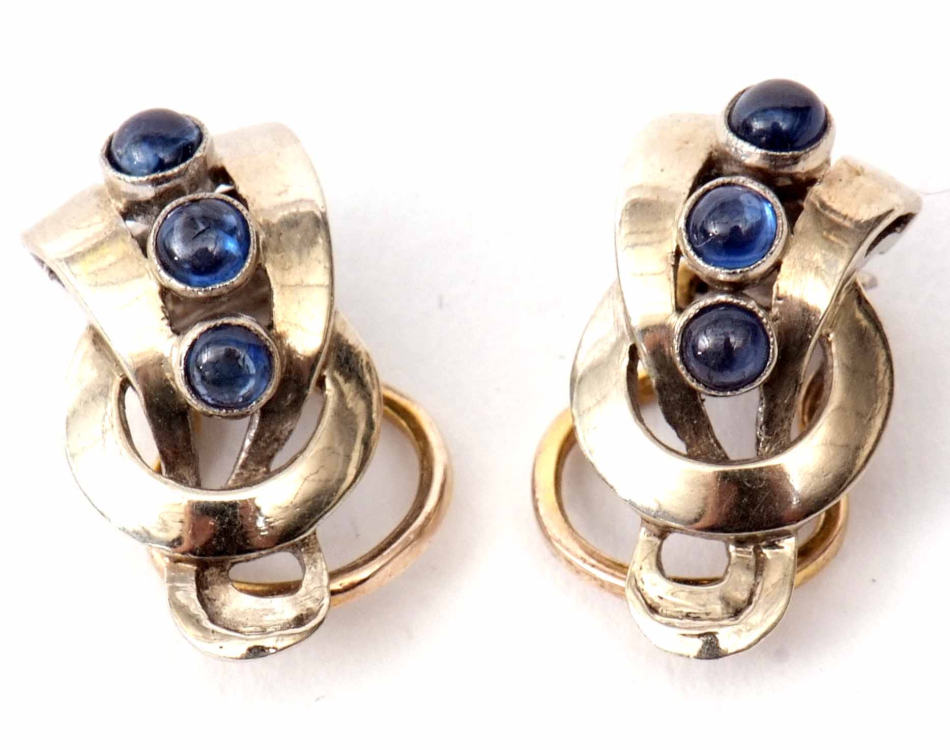 Pair of designer style earrings set with three graduated bezel set cabochon sapphires, each