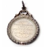 19th century cased Education medallion of circular form with wreath surround and ring suspension