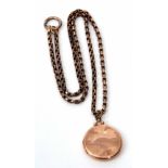 A 9ct gold circular hinged locket, suspended from a 9c stamped oval link chain, gross weight 17.8gms