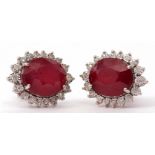 Pair of modern large ruby and diamond cluster earrings, the oval faceted ruby 12 x 10mm, raised