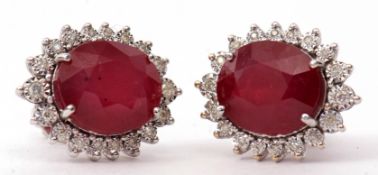 Pair of modern large ruby and diamond cluster earrings, the oval faceted ruby 12 x 10mm, raised