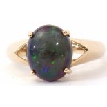 Modern single opal doublet ring, the cabochon four claw set and raised between angular pierced