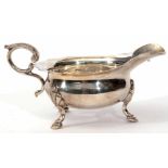 Late Victorian sauce boat of polished form with cut card rim, cast and applied flying c-scroll