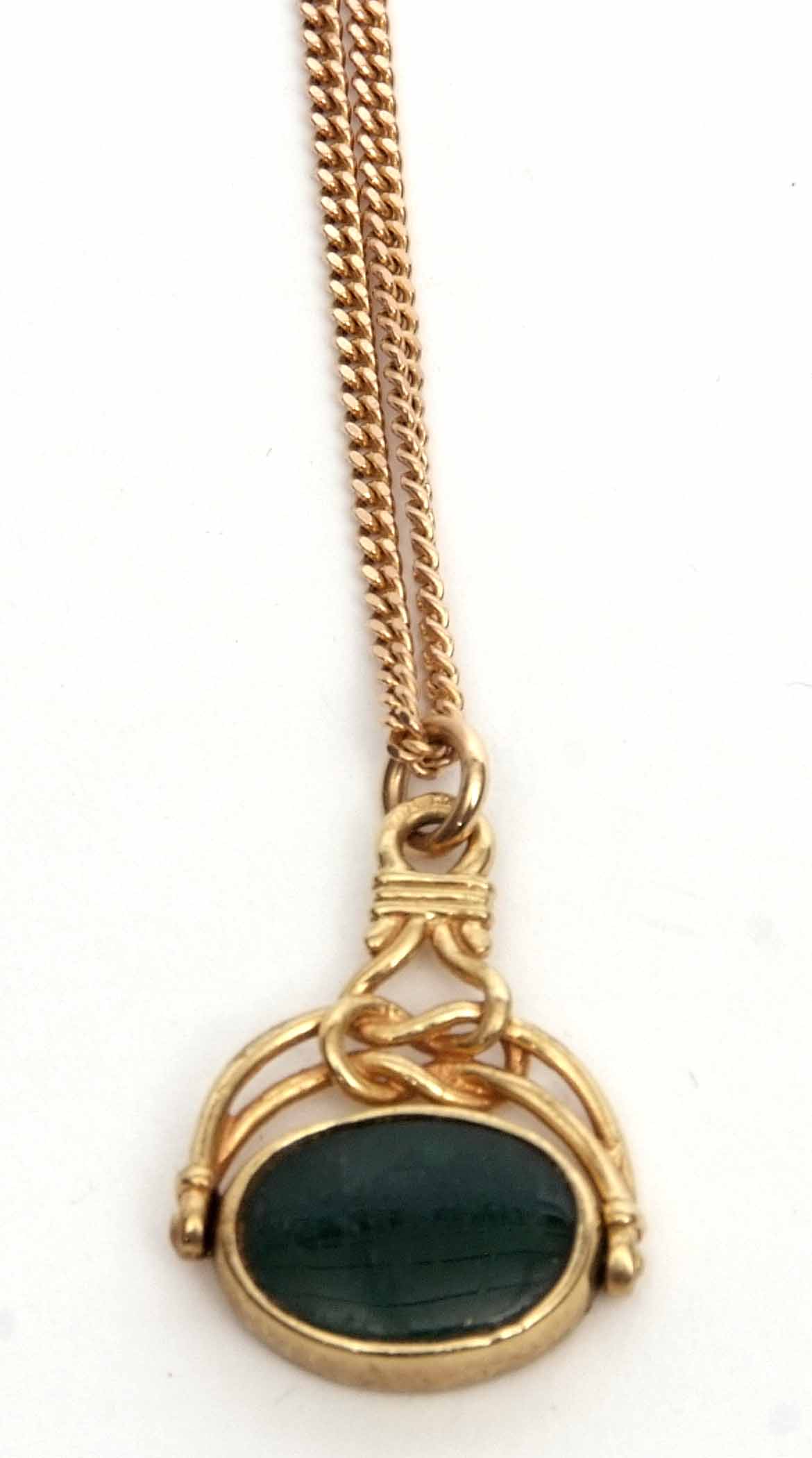 9ct gold framed swivel fob, oval shaped with a bloodstone and onyx panel, suspended from a filed