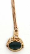 9ct gold framed swivel fob, oval shaped with a bloodstone and onyx panel, suspended from a filed